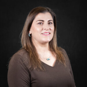 Portrait of Ginger Miller against a dark gray background